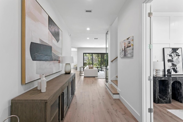 corridor with light hardwood / wood-style flooring