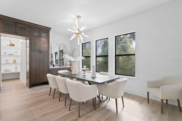 dining room featuring a notable chandelier and light wood-type flooring