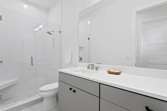 bathroom featuring vanity, toilet, and walk in shower