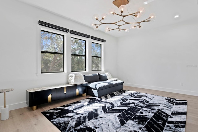 sitting room featuring a notable chandelier and hardwood / wood-style flooring