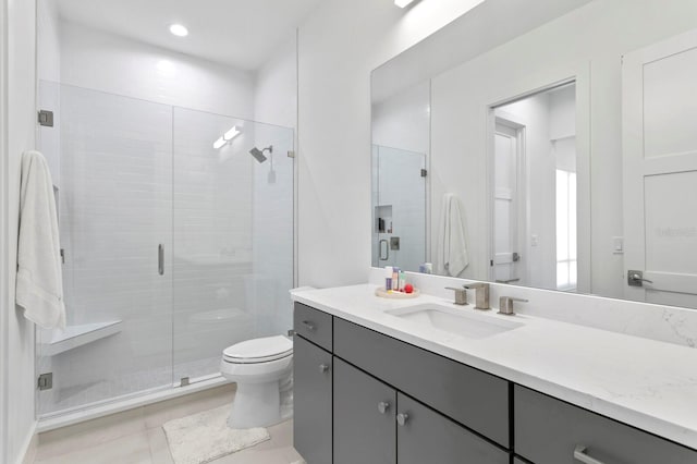 bathroom featuring vanity, tile patterned floors, toilet, and an enclosed shower