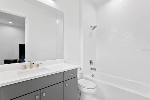 full bathroom featuring toilet, tiled shower / bath, and vanity