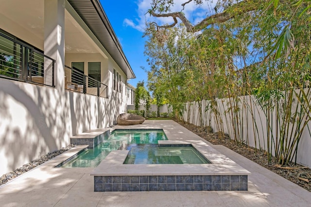 view of swimming pool featuring an in ground hot tub and a patio