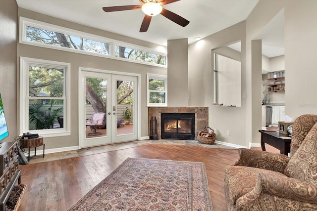 living room with hardwood / wood-style floors, ceiling fan, french doors, and plenty of natural light