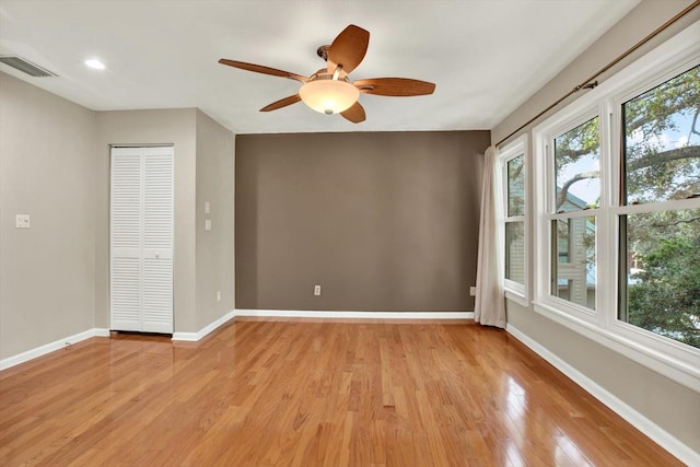 spare room featuring light hardwood / wood-style floors and ceiling fan