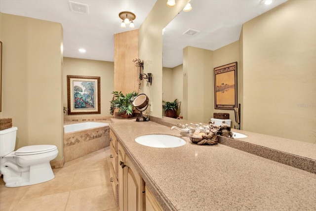 bathroom with vanity, a relaxing tiled tub, toilet, and tile patterned flooring