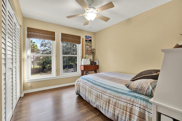 bedroom with dark wood-type flooring and ceiling fan