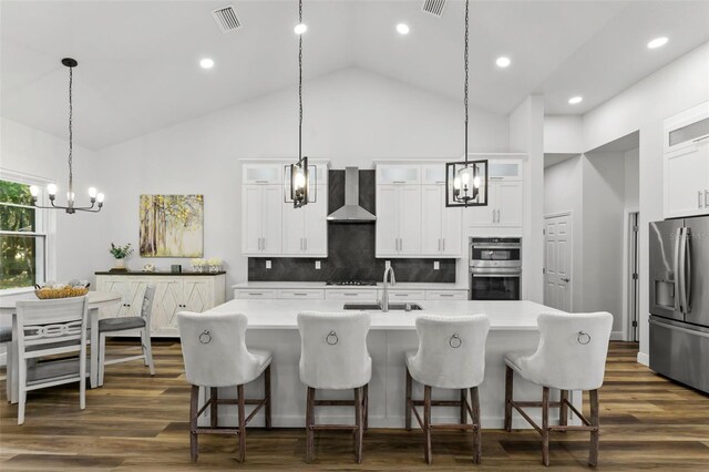 4586 Hickory Oak Dr, Brooksville, FL 34601 - kitchen featuring appliances with stainless steel finishes, a chandelier, wall chimney range hood, a sink, and glass insert cabinets