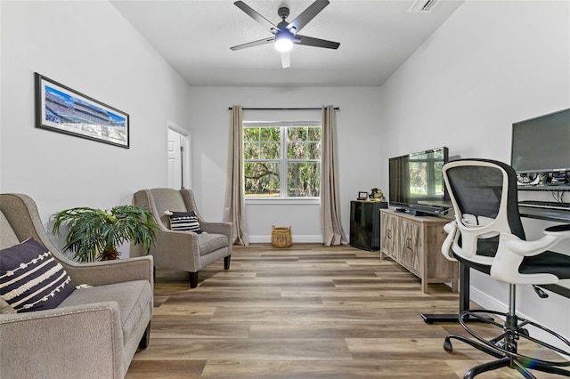 office featuring ceiling fan and light hardwood / wood-style flooring