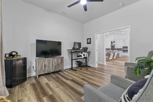 living room featuring hardwood / wood-style flooring and ceiling fan