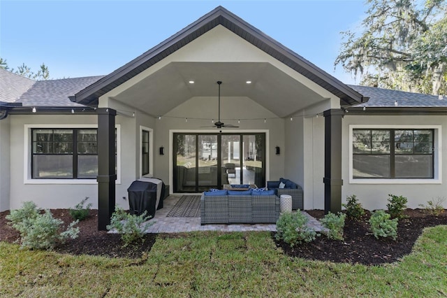 rear view of property with outdoor lounge area, a yard, and ceiling fan