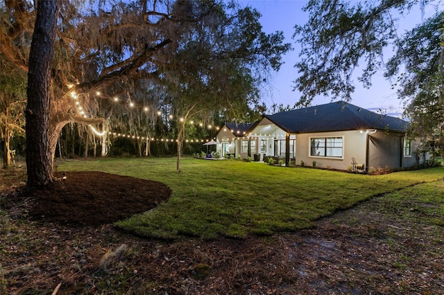 view of yard at dusk