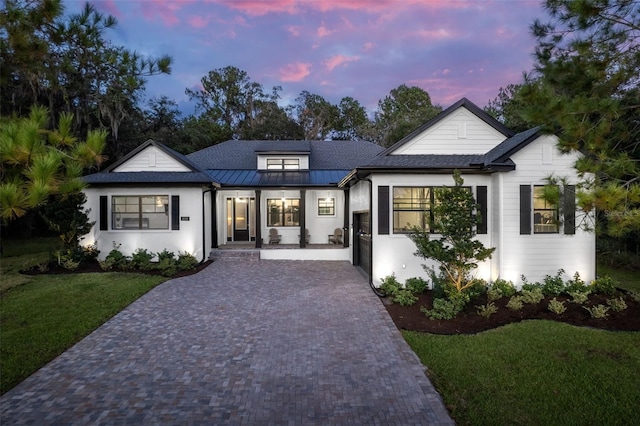 4586 Hickory Oak Dr, Brooksville, FL 34601 - modern farmhouse with a yard, decorative driveway, metal roof, a standing seam roof, and stucco siding