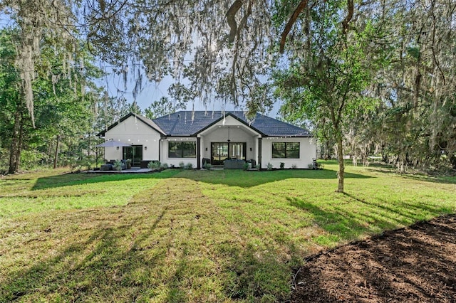 4586 Hickory Oak Dr, Brooksville, FL 34601 - back of property with stucco siding and a yard