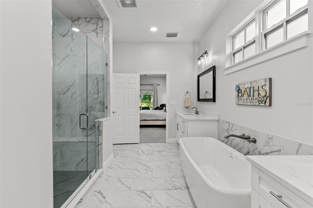 4586 Hickory Oak Dr, Brooksville, FL 34601 - ensuite bathroom with marble finish flooring, healthy amount of natural light, a marble finish shower, a soaking tub, and recessed lighting
