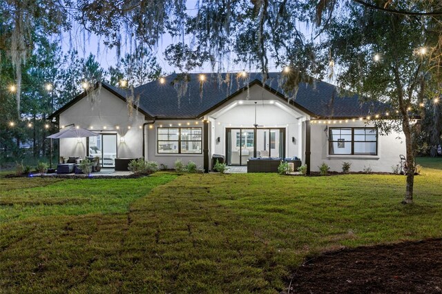 4586 Hickory Oak Dr, Brooksville, FL 34601 - view of front facade with an outdoor living space, a front lawn, stucco siding, and a patio