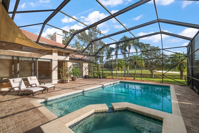 view of pool with a patio, a lanai, and an in ground hot tub