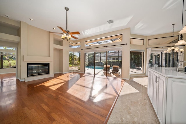 unfurnished living room featuring light hardwood / wood-style flooring and ceiling fan