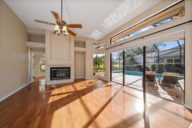 living room with wood-type flooring, a healthy amount of sunlight, and ceiling fan