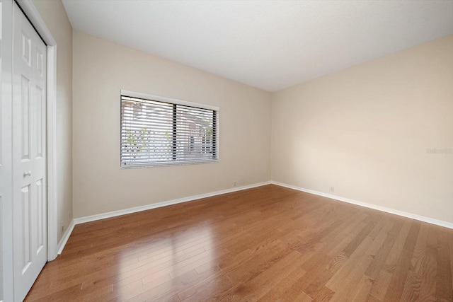 unfurnished bedroom with light hardwood / wood-style floors and a closet