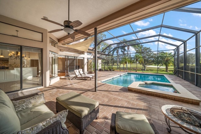 view of pool with an in ground hot tub, a patio area, glass enclosure, and ceiling fan