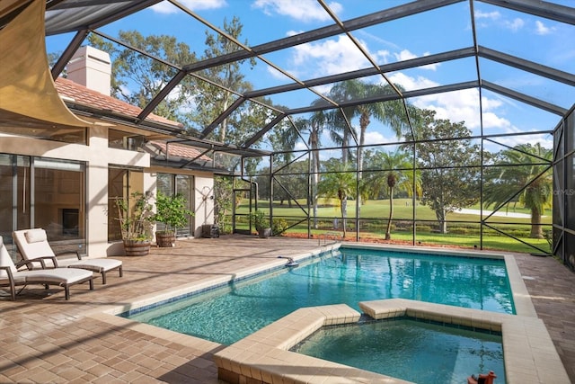 view of swimming pool with an in ground hot tub, a patio, and glass enclosure