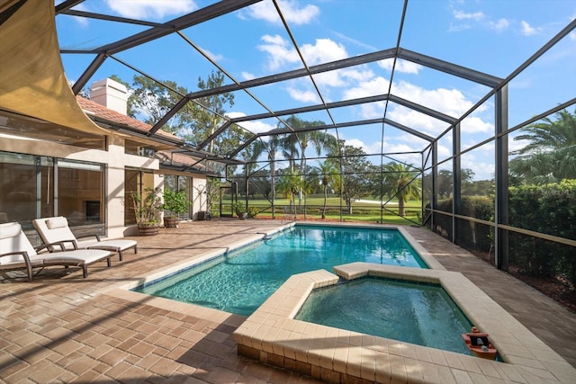 view of pool featuring a patio, an in ground hot tub, and a lanai