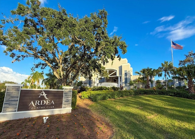 community sign featuring a lawn