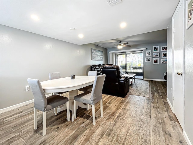 dining space featuring ceiling fan and light wood-type flooring