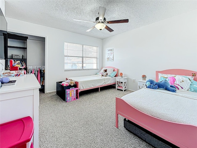 carpeted bedroom with ceiling fan and a textured ceiling