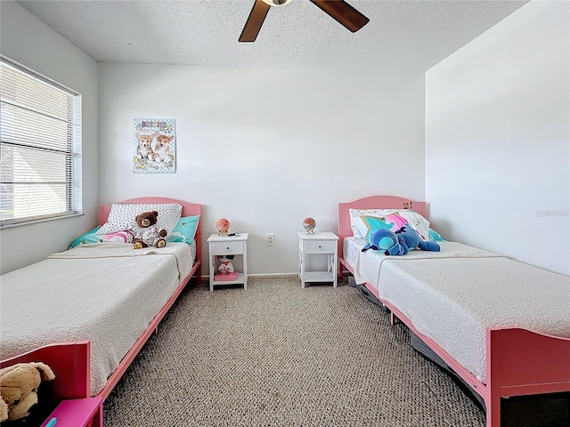 bedroom featuring carpet, ceiling fan, and a textured ceiling