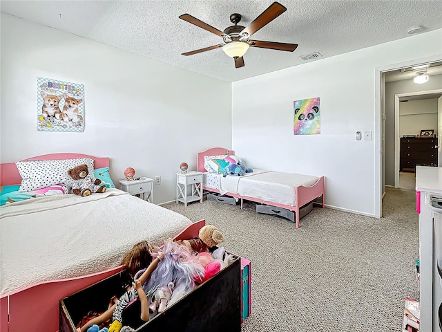 bedroom featuring carpet flooring, a textured ceiling, and ceiling fan