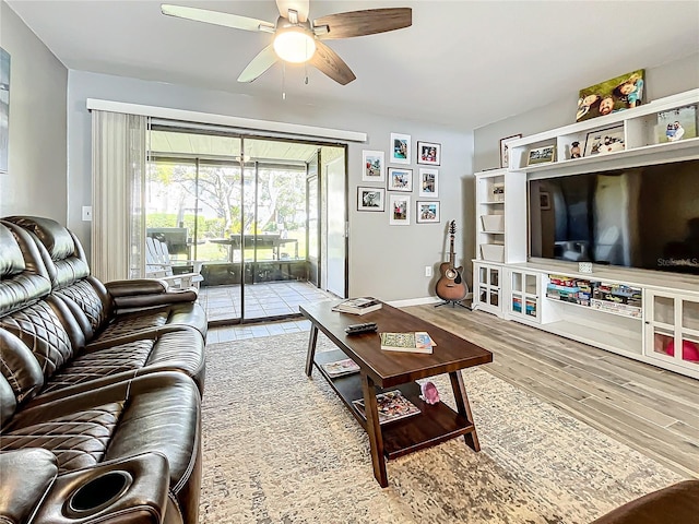 living room with ceiling fan and light wood-type flooring