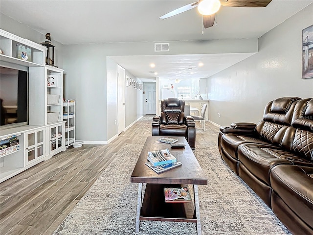 living room with ceiling fan and wood-type flooring