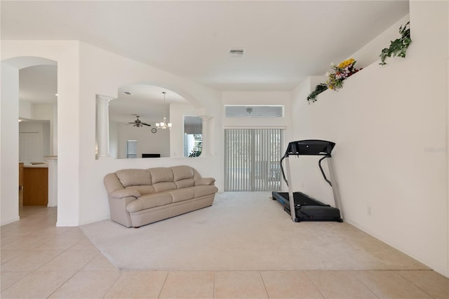 2152 SE Harding St, Port Saint Lucie, FL 34952 - workout area with light tile patterned flooring, light colored carpet, decorative columns, arched walkways, and baseboards