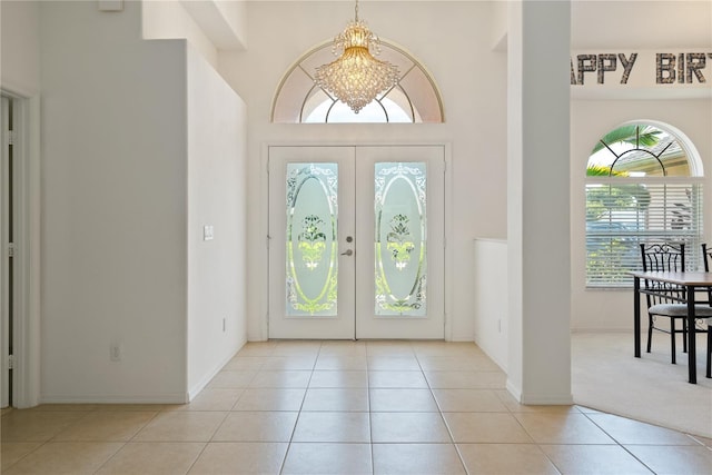 2152 SE Harding St, Port Saint Lucie, FL 34952 - tiled foyer with plenty of natural light, french doors, baseboards, and a chandelier