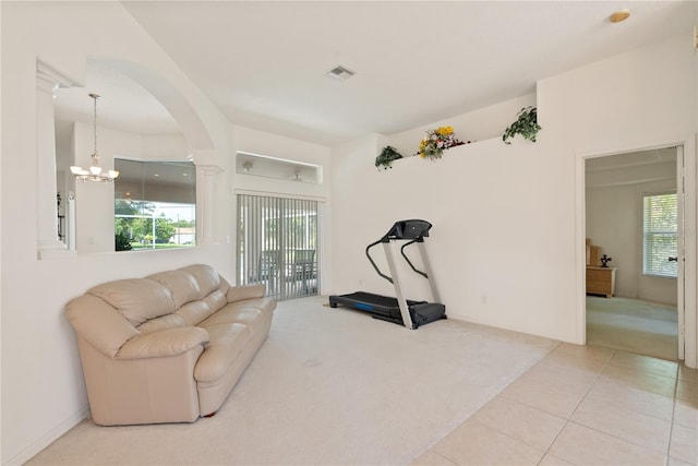 2152 SE Harding St, Port Saint Lucie, FL 34952 - workout room with carpet flooring, arched walkways, a chandelier, and tile patterned flooring