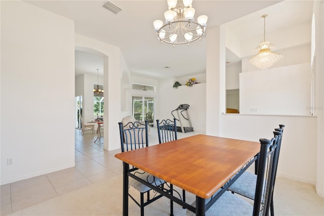 dining room featuring a chandelier and light tile patterned floors