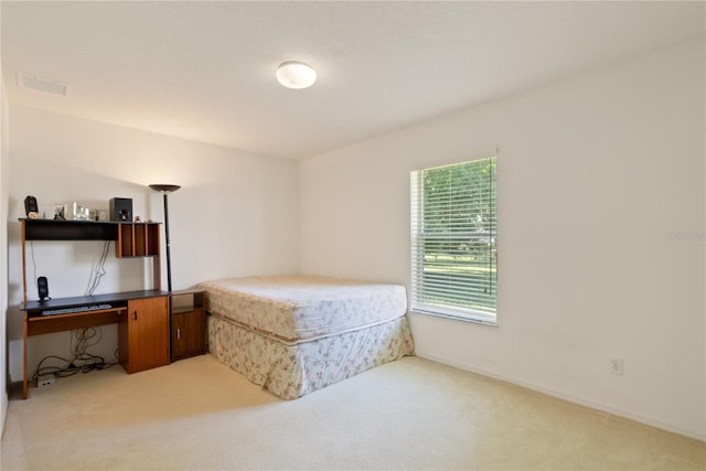 bedroom featuring light carpet