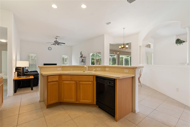 kitchen featuring black dishwasher, decorative columns, a center island with sink, and hanging light fixtures