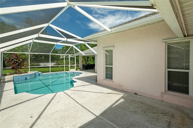 view of swimming pool with a patio area and glass enclosure