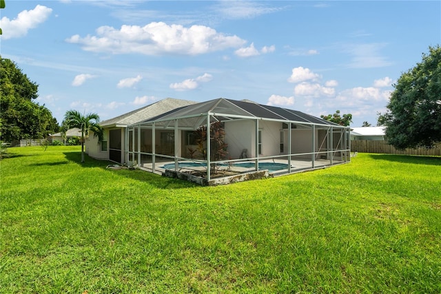 back of house with a fenced in pool, glass enclosure, and a lawn