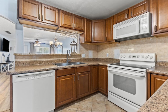 kitchen with sink, decorative backsplash, light tile patterned floors, ceiling fan, and white appliances