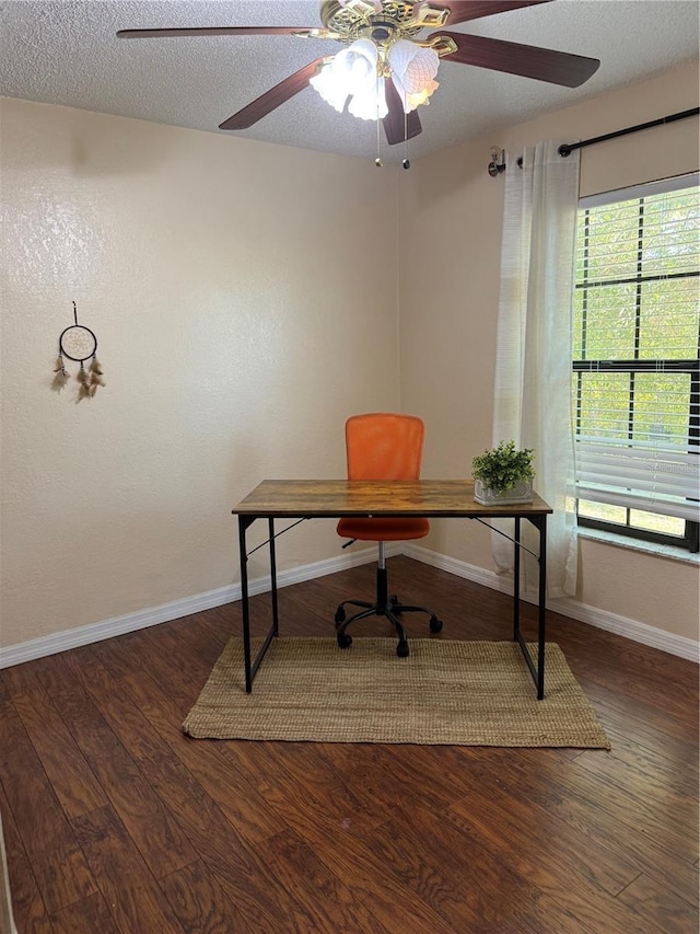 home office with ceiling fan, dark hardwood / wood-style floors, and a textured ceiling