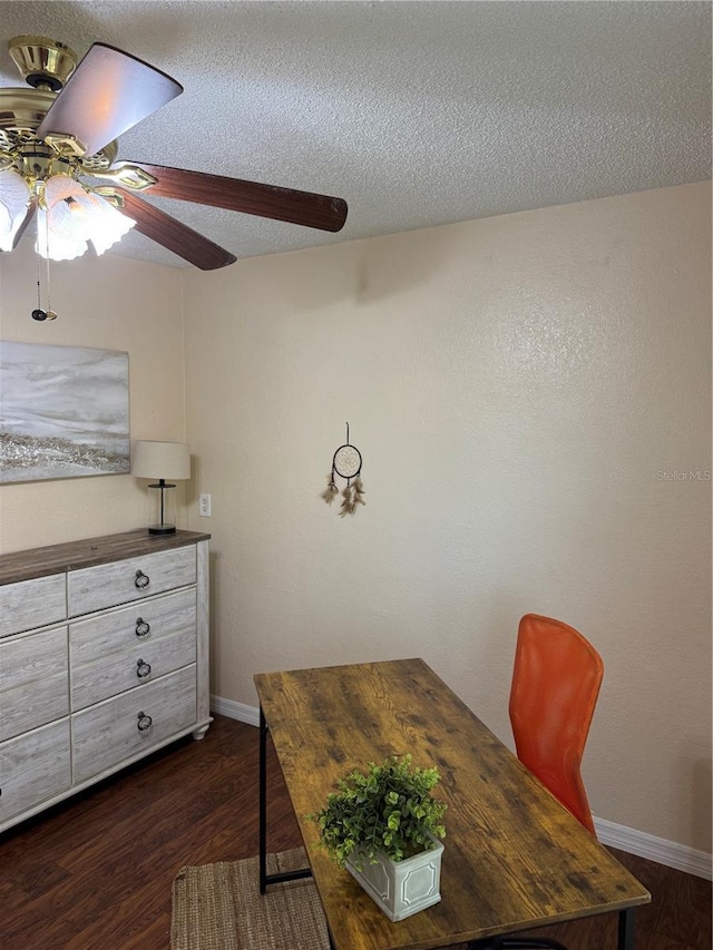 dining area featuring dark wood-type flooring, ceiling fan, and a textured ceiling