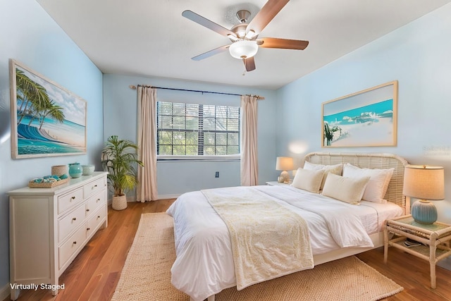 bedroom with ceiling fan and light hardwood / wood-style floors