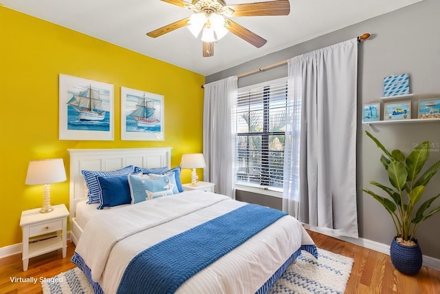 bedroom featuring hardwood / wood-style floors and ceiling fan