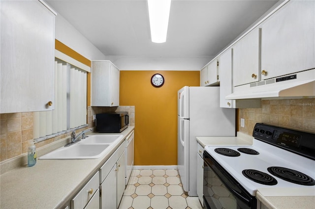 kitchen with white appliances, white cabinetry, sink, and decorative backsplash