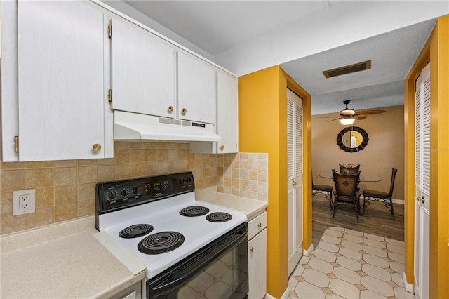 kitchen featuring decorative backsplash, white electric range, light hardwood / wood-style flooring, white cabinets, and ceiling fan