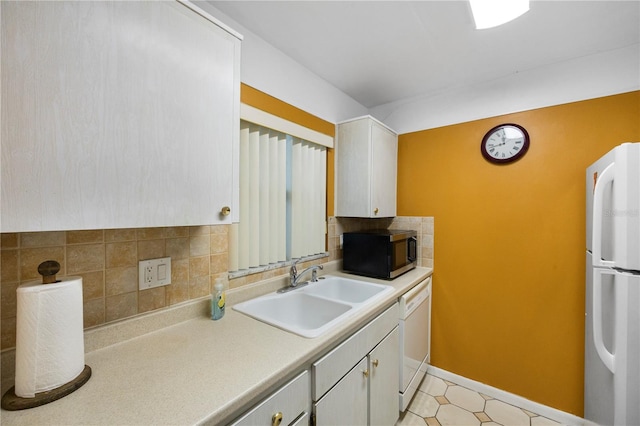 kitchen featuring white appliances, tasteful backsplash, white cabinetry, and sink